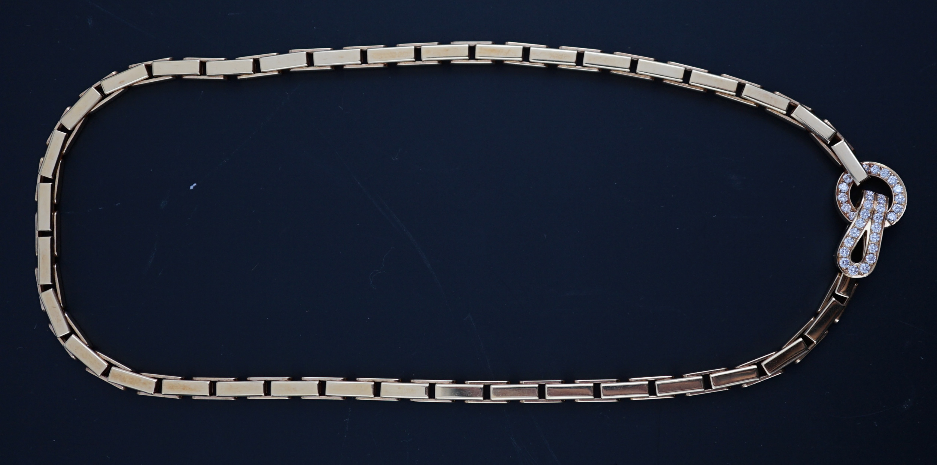 A modern Cartier 18ct gold necklace, with diamond cluster set clasp